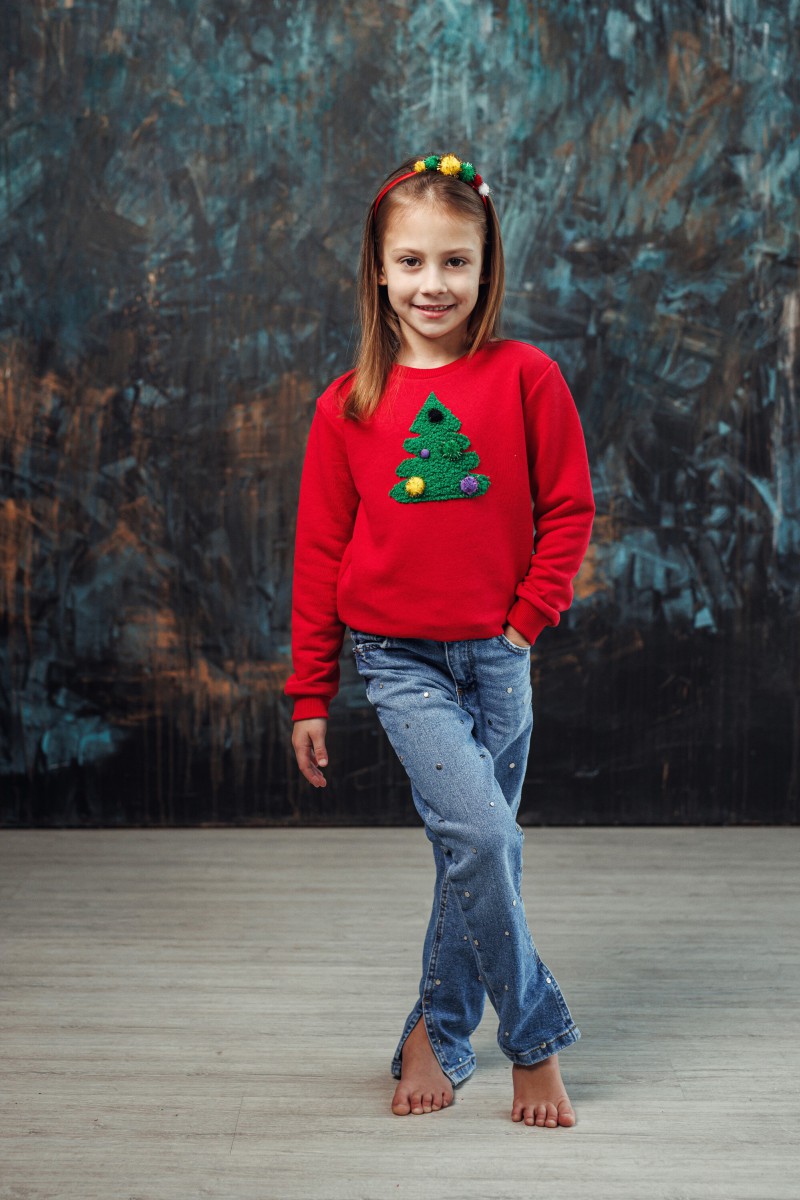Girl's red Christmas jumper with a decorated Christmas tree
