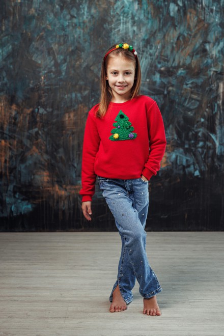 Girl's red Christmas jumper with a decorated Christmas tree