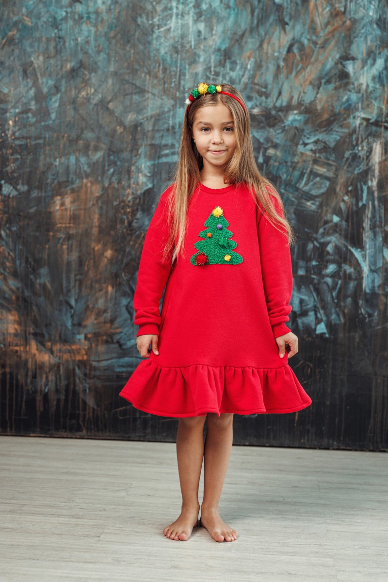 Girl's red dress with a ruffle and a decorated Christmas tree – photo 2