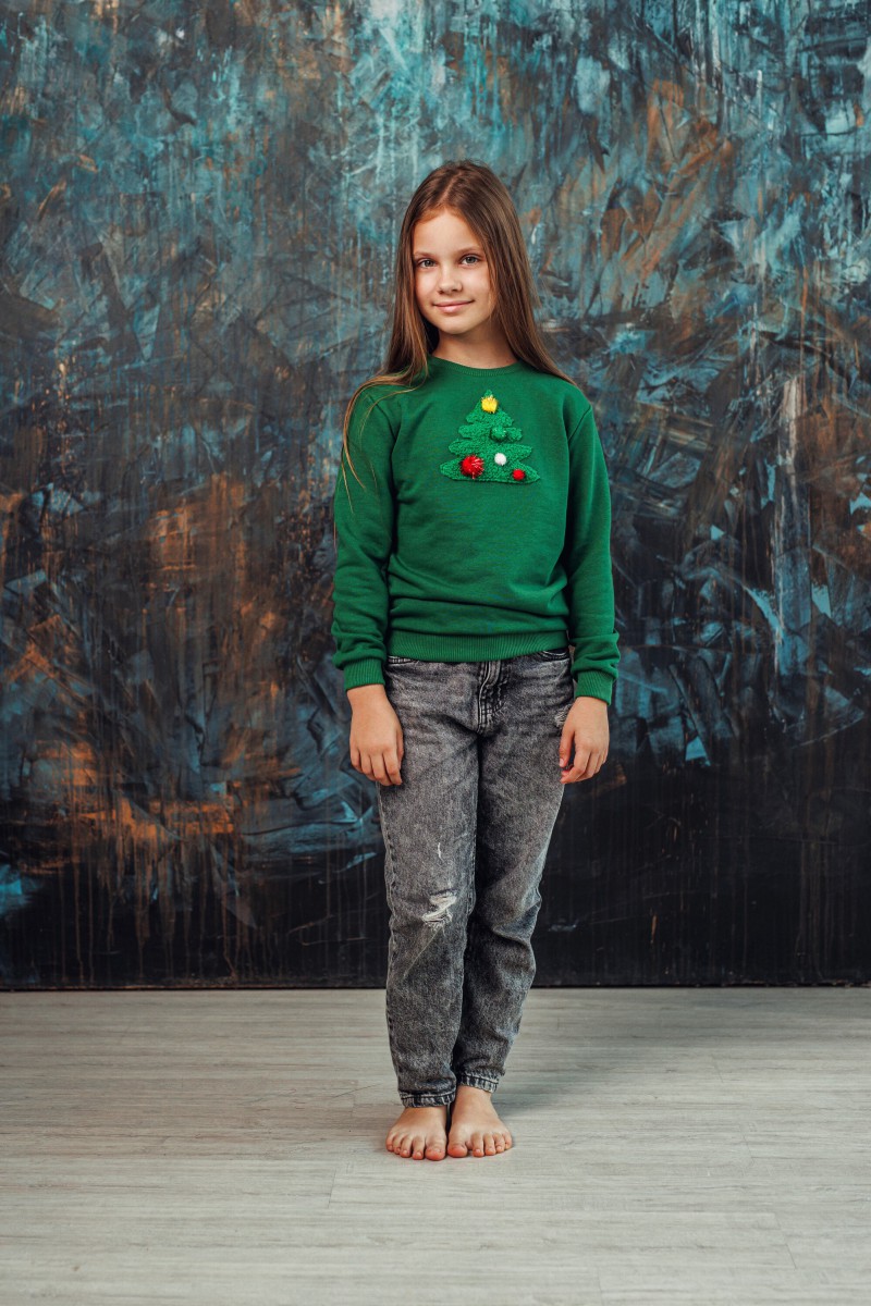 Girl's green Christmas jumper with a decorated Christmas tree