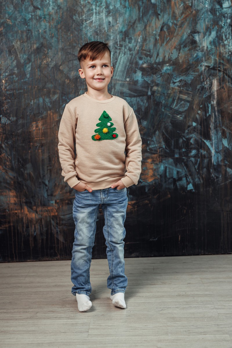 Boy's sand Christmas jumper with a decorated Christmas tree