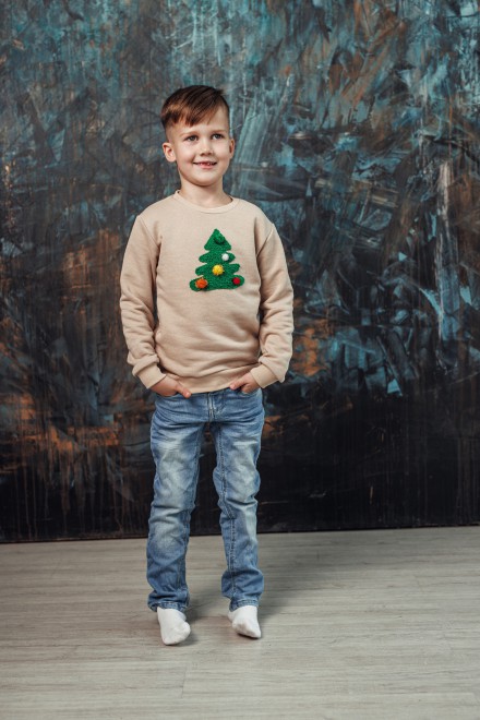 Boy's sand Christmas jumper with a decorated Christmas tree