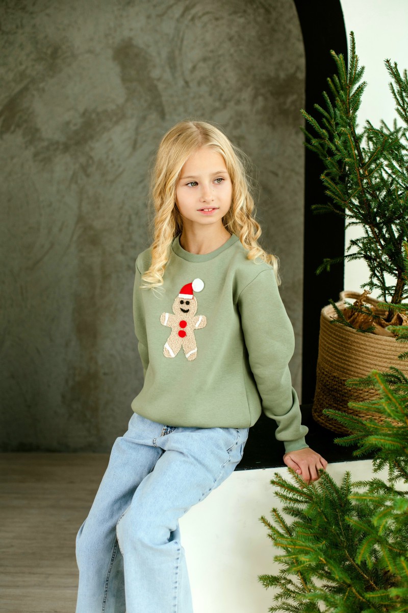 Girl's pale green Christmas jumper with gingerbread