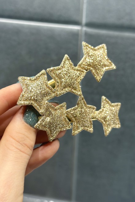 Shiny gold hair clip with 3 stars