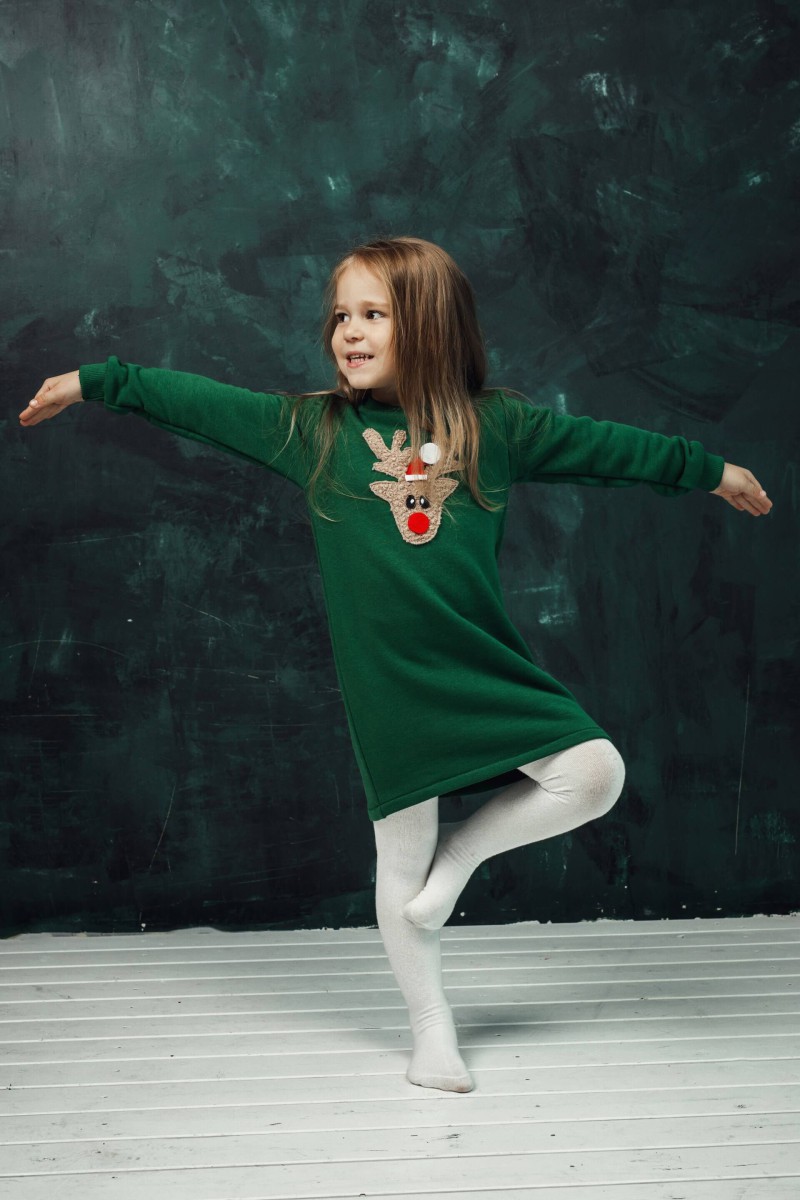 Girl's green dress with a soft reindeer