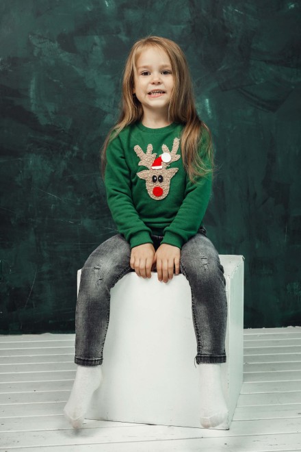 Girl's green Christmas jumper with a soft reindeer