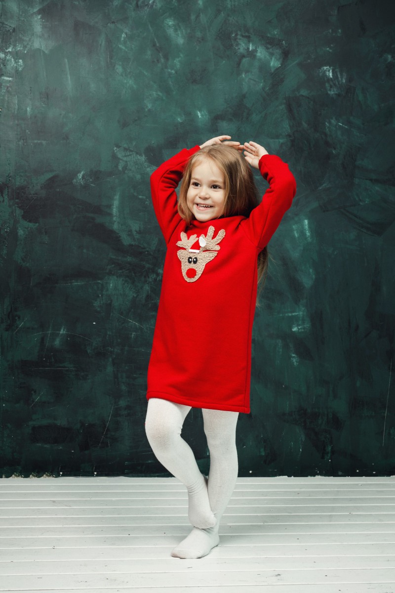 Girl's red dress with a soft reindeer